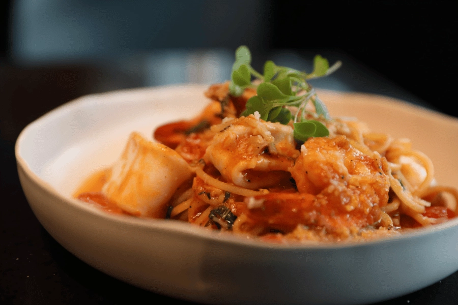 Italian pasta dish with cheese and tomato sauce served in a bowl